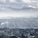 Misty scene of Penrith town in cloud inversion, with Helvellyn and fells beyond