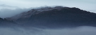 Cold air mist forming on Loughrigg Fell near Grasmere in Winter