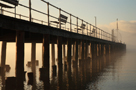 Sun breaking through morning mist, Pooley Bridge Old Pier, Ullswater in winter