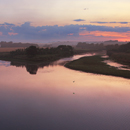 Twilight at Whiteadder Point on the River Tweed near Berwick, Northumberland with a gull flying up river