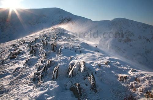 Swirral Edge Helvellyn, ice, sun, spindrift and rocks, Lake District