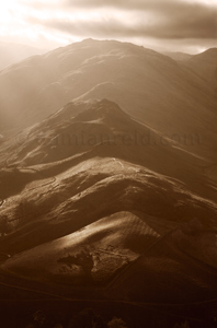 View of Winter Crag, Beda Fell, Angletarn Pikes lit by rays of sunlight. Taken from Hallin Fell, Lake District