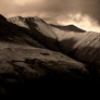Blencathra - Click to enlarge Dramatic image of Blencathra or Saddleback with Halls Fell Ridge and crags lit by evening sun, with rest of mountain in shadow
