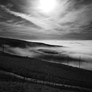 Powerful sky with sun lighting fells and Hartside pass, Cumbria above cloud inversion