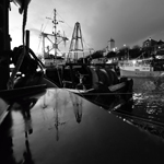 Last light at North Shields fish quay, Tyne & Wear, with boats, quayside and Low Lights in background  