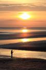 Calm evening sunset over Silverdale Sands, Morecambe Bay with fisherman