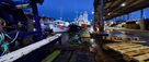 Fishing boats, nets and pallets on quayside with the Low Light in background